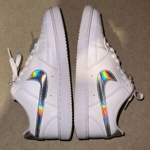 White Nikes with metallic silver swoosh